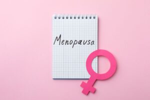 Bloc-notes con scritto menopausa e simbolo femminile
