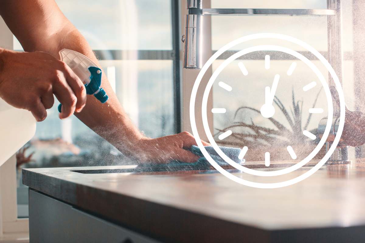 mano pulisce piano cucina e simbolo orologio