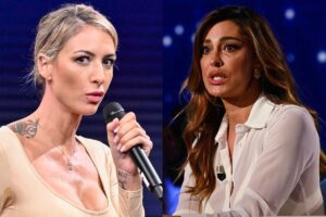 Ema Stokholma con il microfono in mano e Belen con espressione interdetta